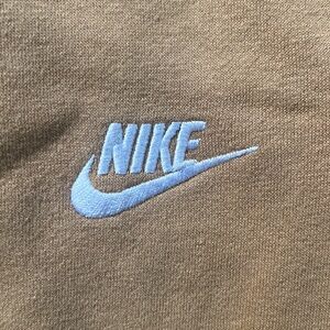 Men’s small Nike sweatpants. Orangish tan color with pockets.